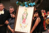 People holding picture of Saint Guadalupe